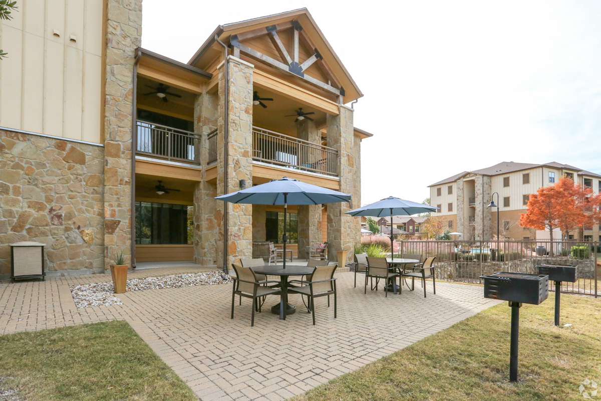 Outdoor grilling courtyard with umbrella-covered table